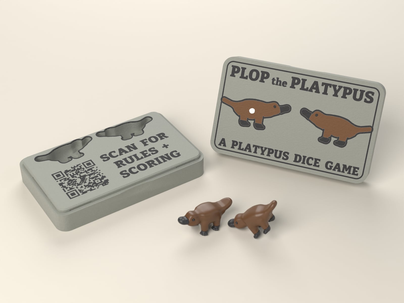 The open Plop the Platypus case with its lid standing beside it and two platypus dice in front